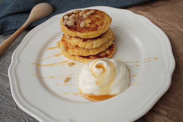 istock Russian sweet cheese pancakes with sour cream 615235676
