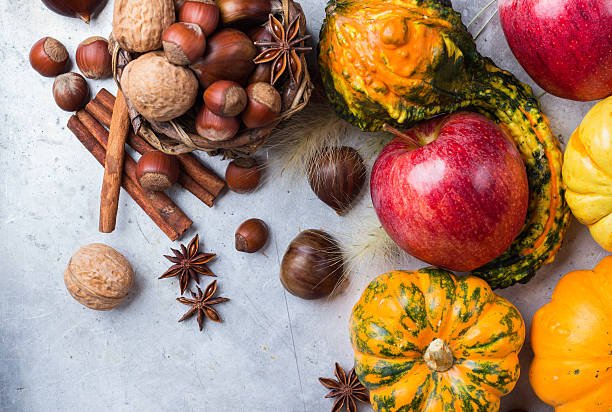 istock Autumn fall halloween still life composition with pumpkin nuts chestnut 615237206