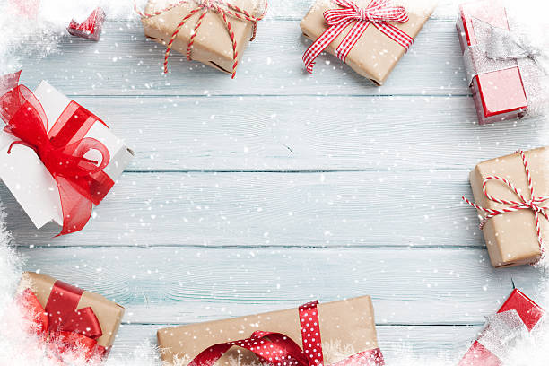 istock Christmas gift boxes on wooden table 615237440
