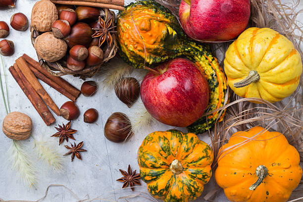 istock Autumn fall halloween still life composition with pumpkin nuts chestnut 615237600