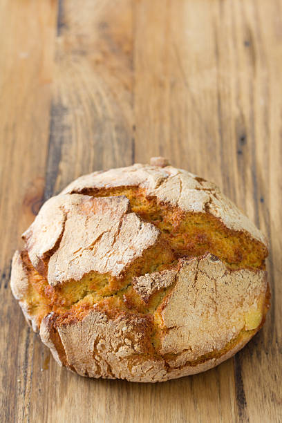 istock portuguese bread on brown wooden background 615238300