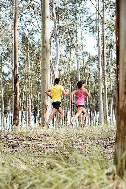 istock Couple doing running exercises workout training outdoor at forest 615239770