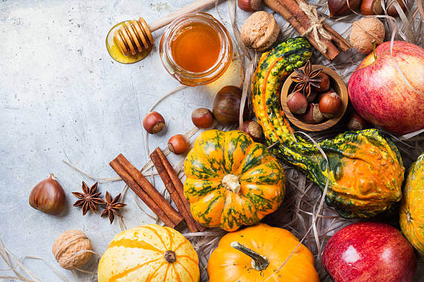 istock Autumn fall halloween still life composition with pumpkin nuts chestnut 615240990