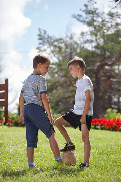 istock Two boys playing football 615241882