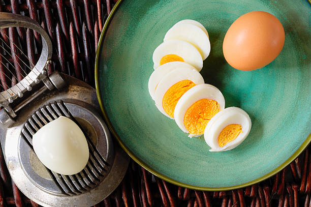 Hardboiled Egg Cut And Piled On Egg Slicer Stock Photo - Download Image Now  - Animal Egg, Appliance, Boiled - iStock