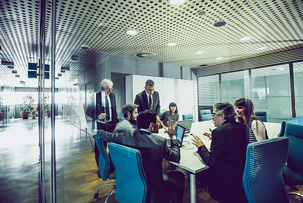 People Having a Business Meeting Business People Having a Meeting merger stock pictures, royalty-free photos & images