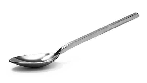 istock beautiful Stainless steel glossy metal kitchen spoon isolated 615243936