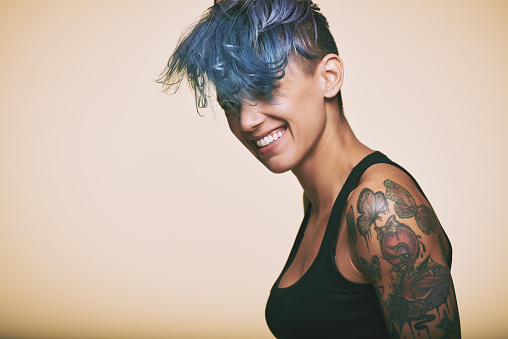 Portrait of laughing teenage girl with blue hair