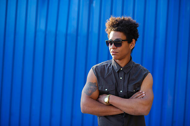 istock afro american curly young man on blue wall 615244782
