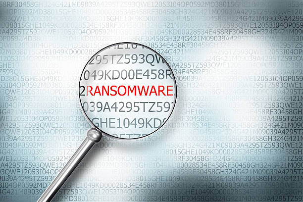 reading ransomware on computer screen magnifying glass 3d illust - data leak stockfoto's en -beelden
