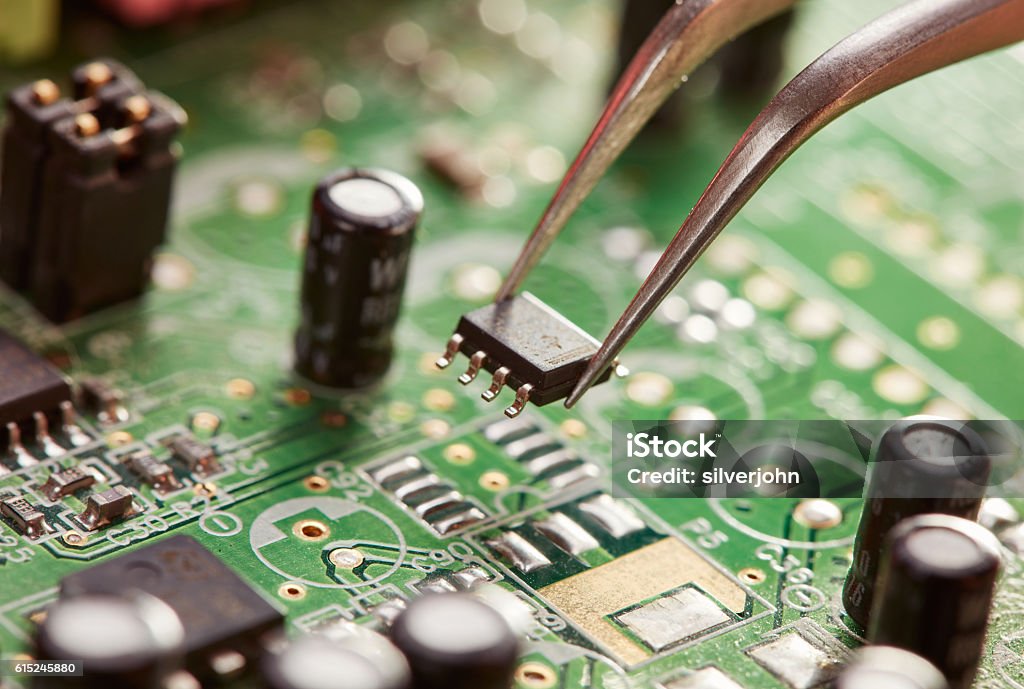 Tweezers with chip Circuit Board Stock Photo