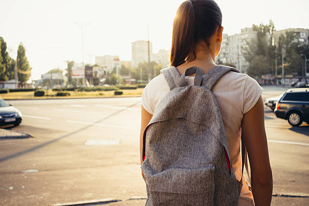 istock Slender young brunette in a shirt and a backpack 615245948
