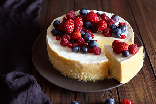  Creamy mascarpone cheese cake with strawberry and winter berries. New York Cheesecake. Christmas mousse dessert. Healthy food ration.