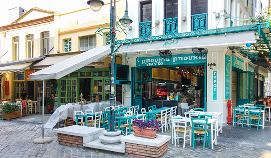 Thessaloniki, Greece - August 31, 2016: Ladadika quarter in thessaloniki, restaurant tables long the street, photo taken at early morning, Greece