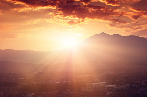 sunset and sun beams over the mountains of the city of prizren, Kosovo