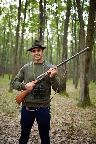 istock Hunter with shotgun in the forest 615256790