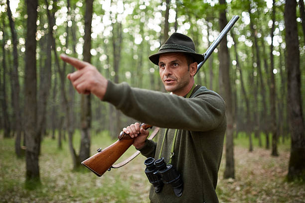 istock Hunter with shotgun in the forest 615257062