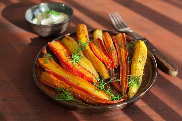 istock roasted colorful carrots on plate 615259908