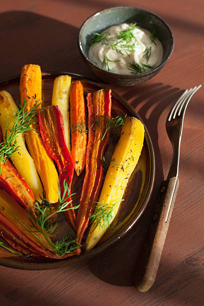 istock roasted colorful carrots on plate 615260072