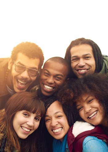 Portrait of a happy group of friends posing together outside