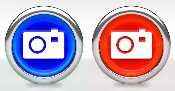 Digital Camera Icon on Button with Metallic Rim. The icon comes in two versions blue and red and has a shiny metallic rim. The buttons have a slight shadow and are on a white background. The modern look of the buttons is very clean and will work perfectly for websites and mobile aps.