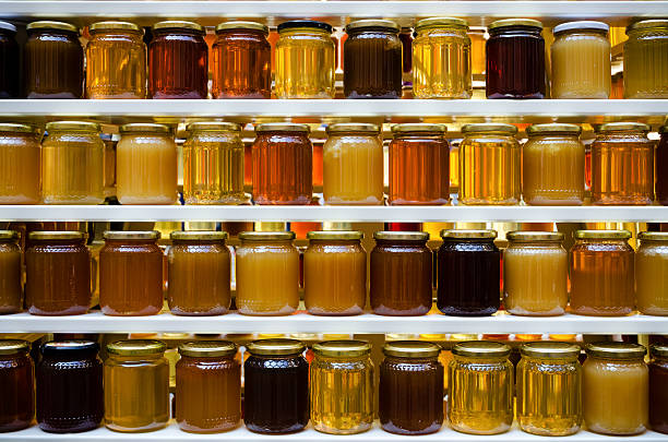 honey jars on a shelf stock photo