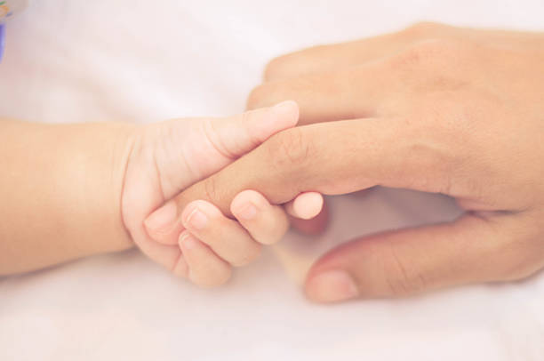 istock Holding baby hand vintage style color effect 615264030