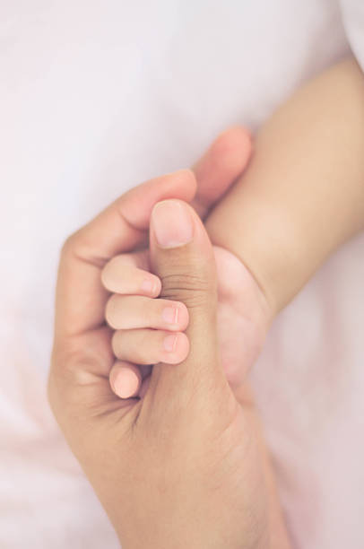 istock Holding baby hand vintage style color effect 615264062