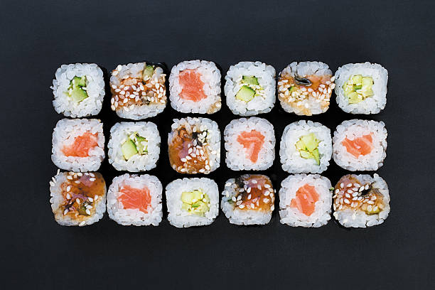 rolls Mix of Japanese nori rolls in on a black background japanese food photos stock pictures, royalty-free photos & images