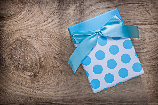 istock Blue wrapped present box on wooden board celebrations concept 615265584