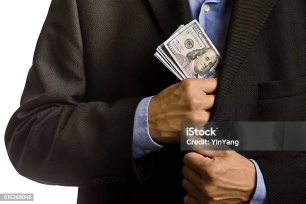 Corporate Businessman Slipping Us Dollars Money Into Suite Pocket Stock Photo - Download Image Now