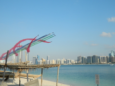 Aircraft show performed in Abu Dhabi city, celebrating the UAE National Day. In this Picture several colors are being displayed by the jets over the city. DATE: 02-DEC-2014.