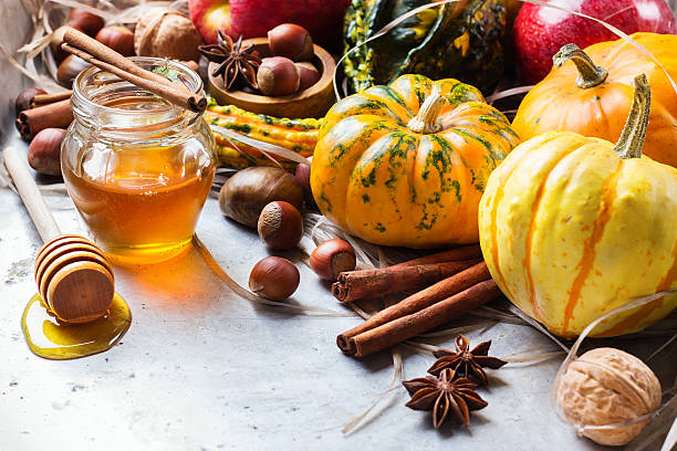 istock Autumn fall halloween still life composition with pumpkin nuts chestnut 615268868