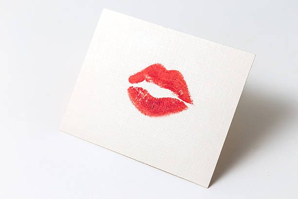 istock Lipstick kiss on white paper sheet 615269902