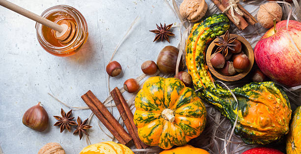 istock Autumn fall halloween still life composition with pumpkin nuts chestnut 615270036