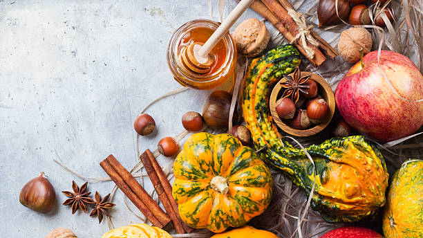 istock Autumn fall halloween still life composition with pumpkin nuts chestnut 615270234