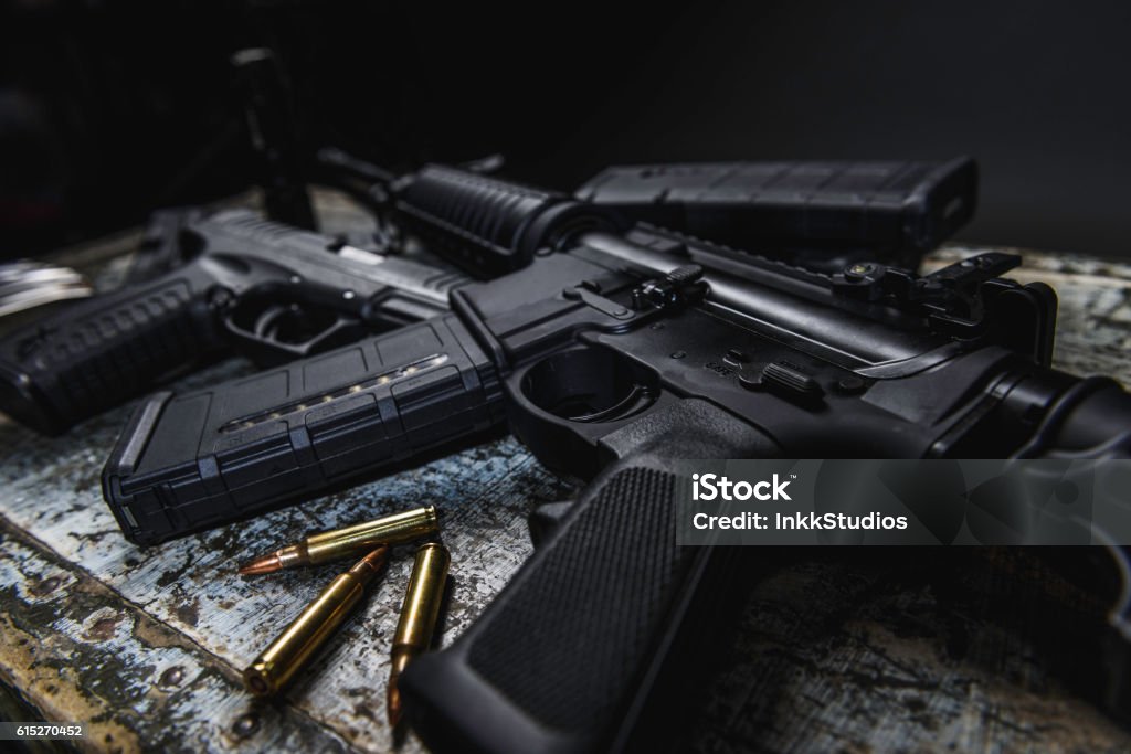 AR 15 AR 15 with ammunition laying near it. Rifle Stock Photo