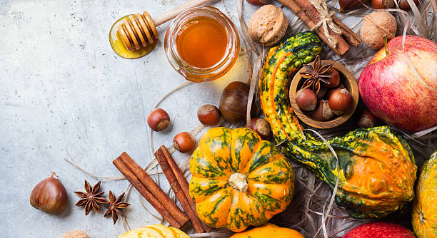 istock Autumn fall halloween still life composition with pumpkin nuts chestnut 615270744