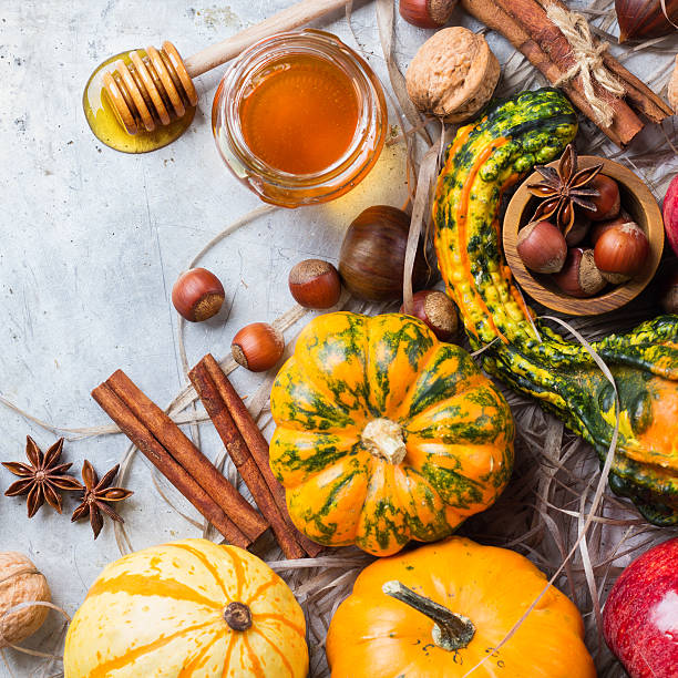istock Autumn fall halloween still life composition with pumpkin nuts chestnut 615270850