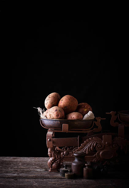 istock Potato on vintage rusted weight 615271030