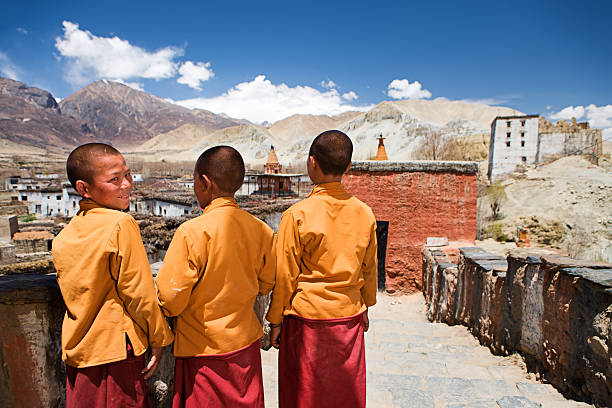 three young novice monks in tibetan monastery, upper mustang - novice buddhist monk imagens e fotografias de stock