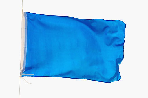 Blue flag waving isolated on a white background. Promotional and advertisement object