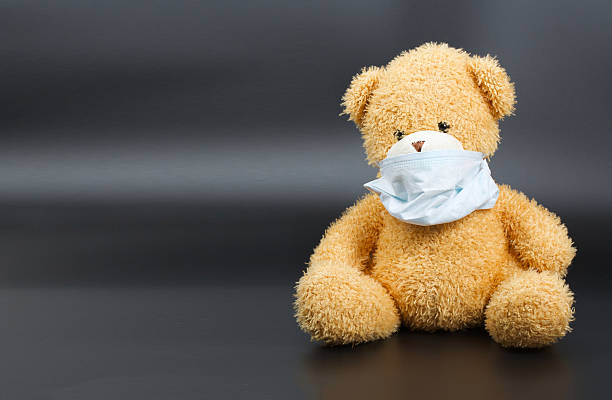 istock Plush teddy bear in a medical mask 615272920
