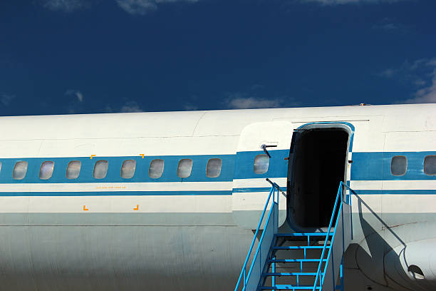 istock Old passenger aircraft windows and open door 615272954