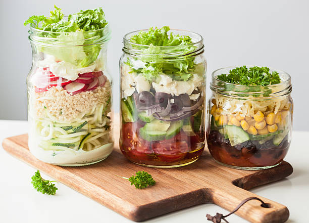 istock healthy vegetable cheese salad in mason jars 615273570