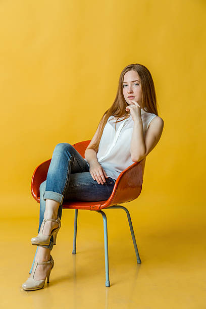 istock Young beautiful woman sitting on chair 615273704