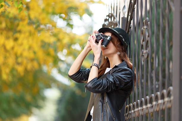 istock Young girl with camera outdoors 615274164