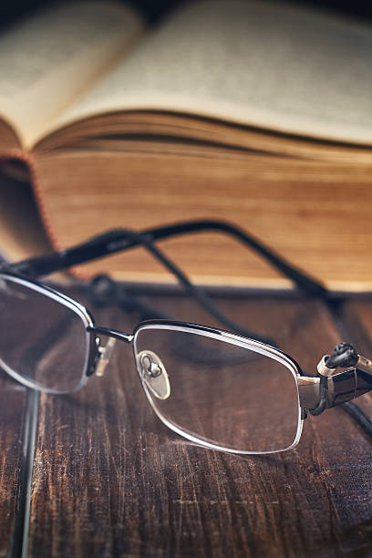 istock Reading glasses in front of old yellow book 615275980