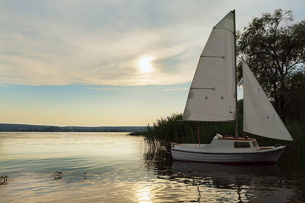 istock Moored boat with sail at sunset, lake. 615276308