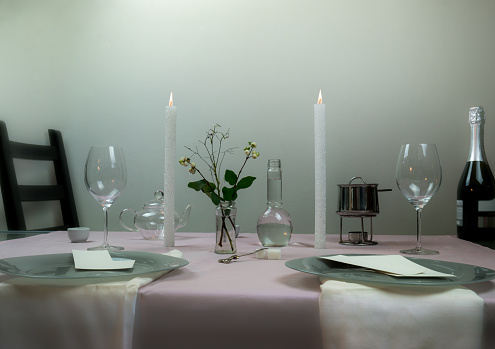 table setting. romantic dinner, wine glasses, flowers in a vase, candle